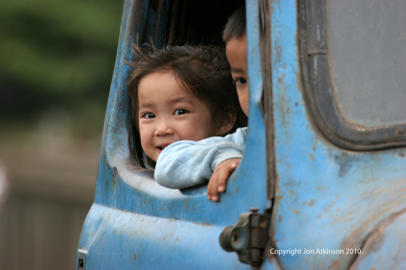 Children in Car, Laos Road Scene
